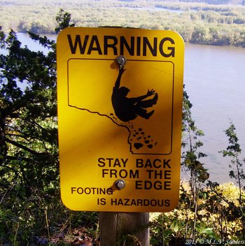 warning sign on high bluff above the Mississippi River at Effigy Mounds National Monument in Iowa