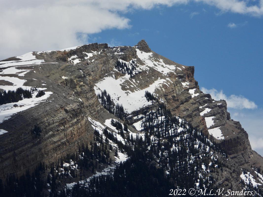 The mountain White Rock partially clad in snow. Green River Lakes.